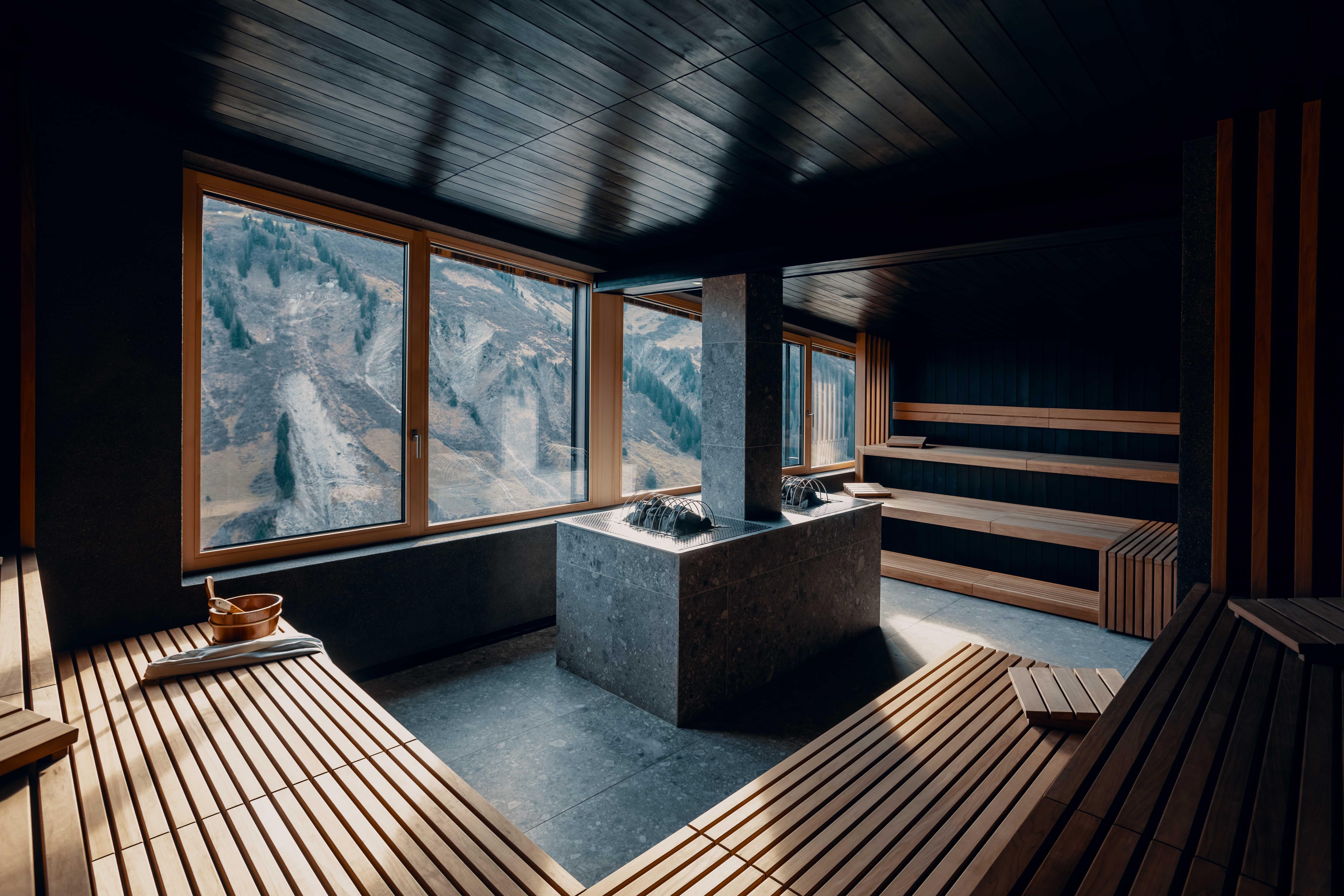 architectural photograph of a sauna with panoramic window looking into the mountain landscape.