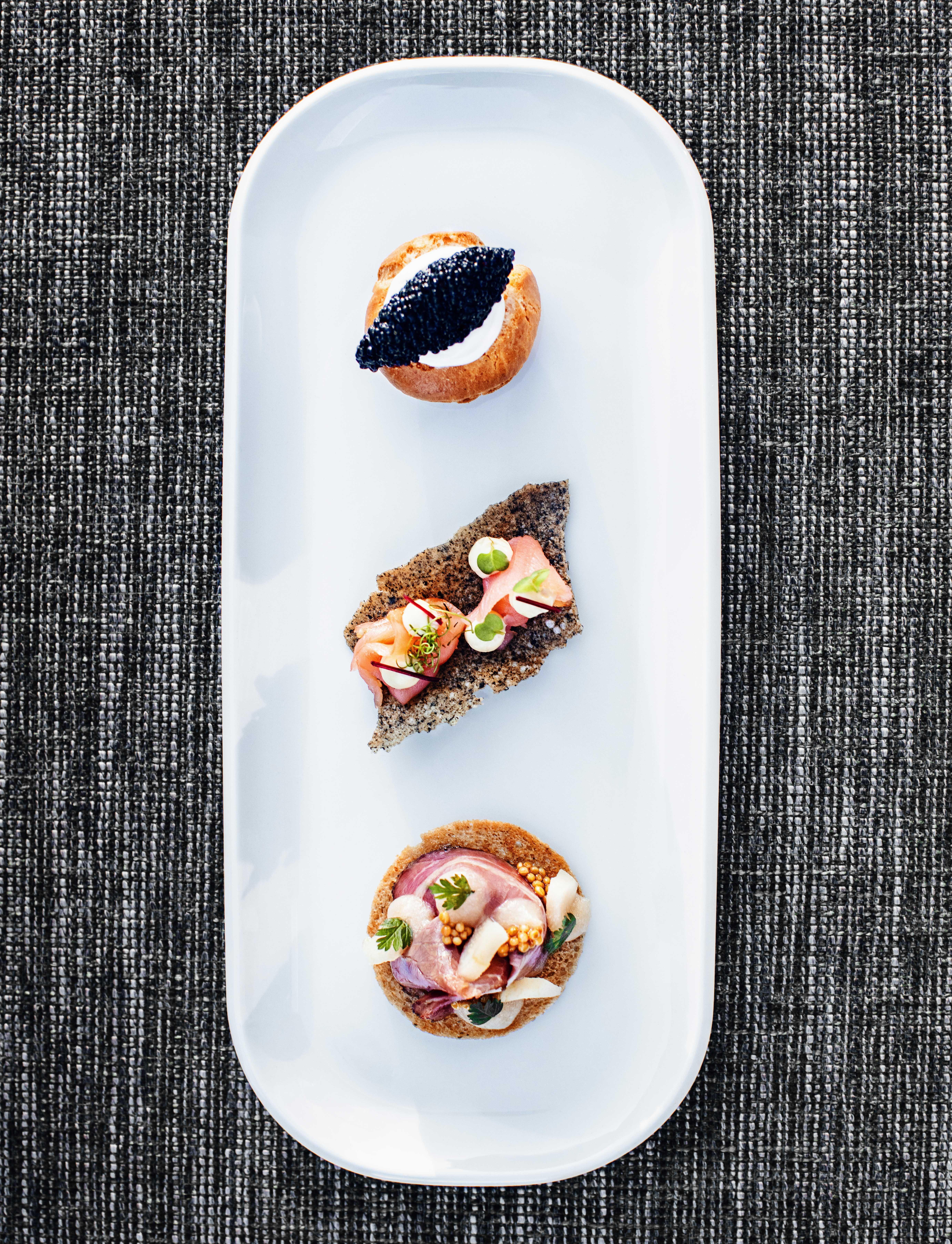 an oblong plate with three different appetizers.