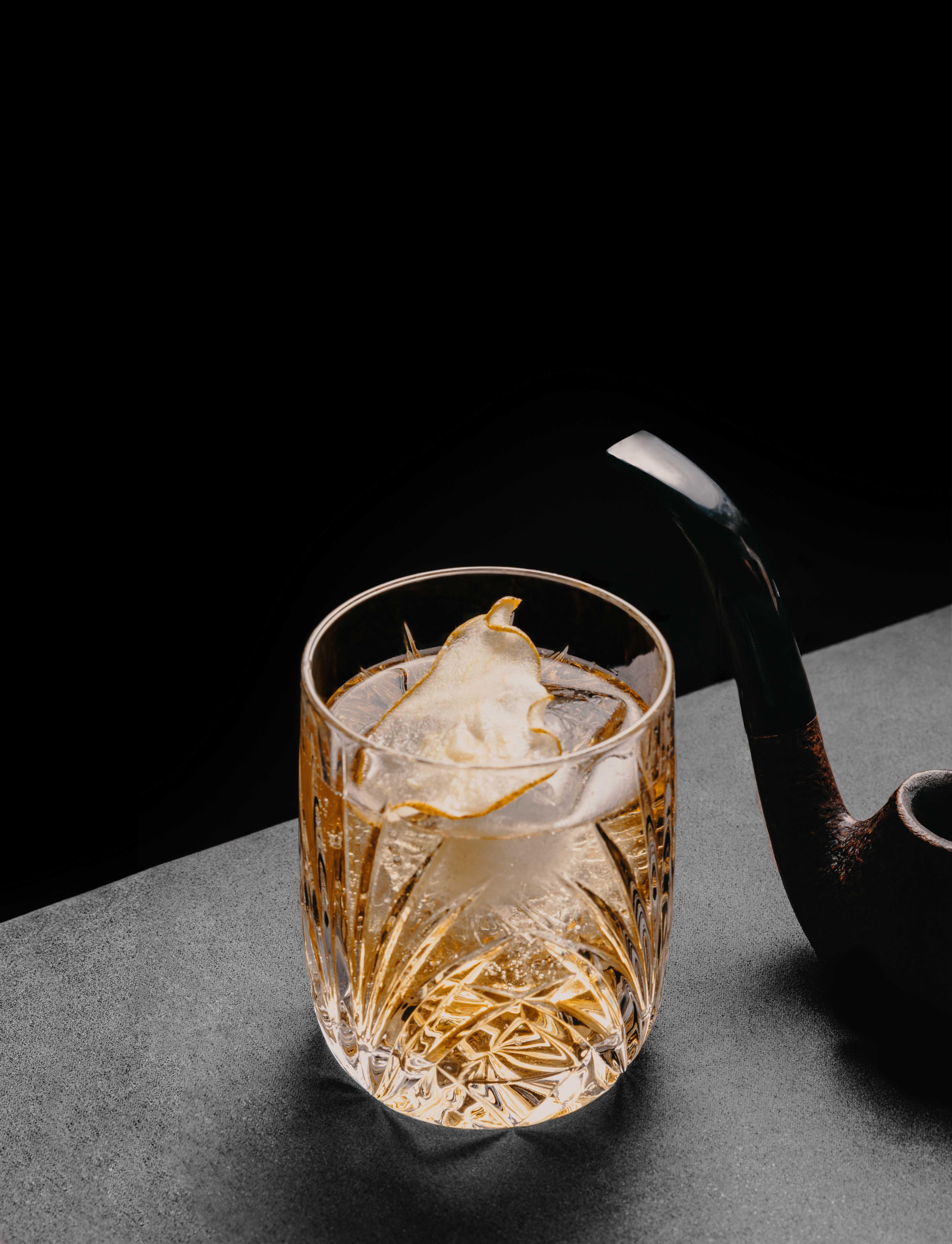 photo of a cocktail with a pipe next to it.