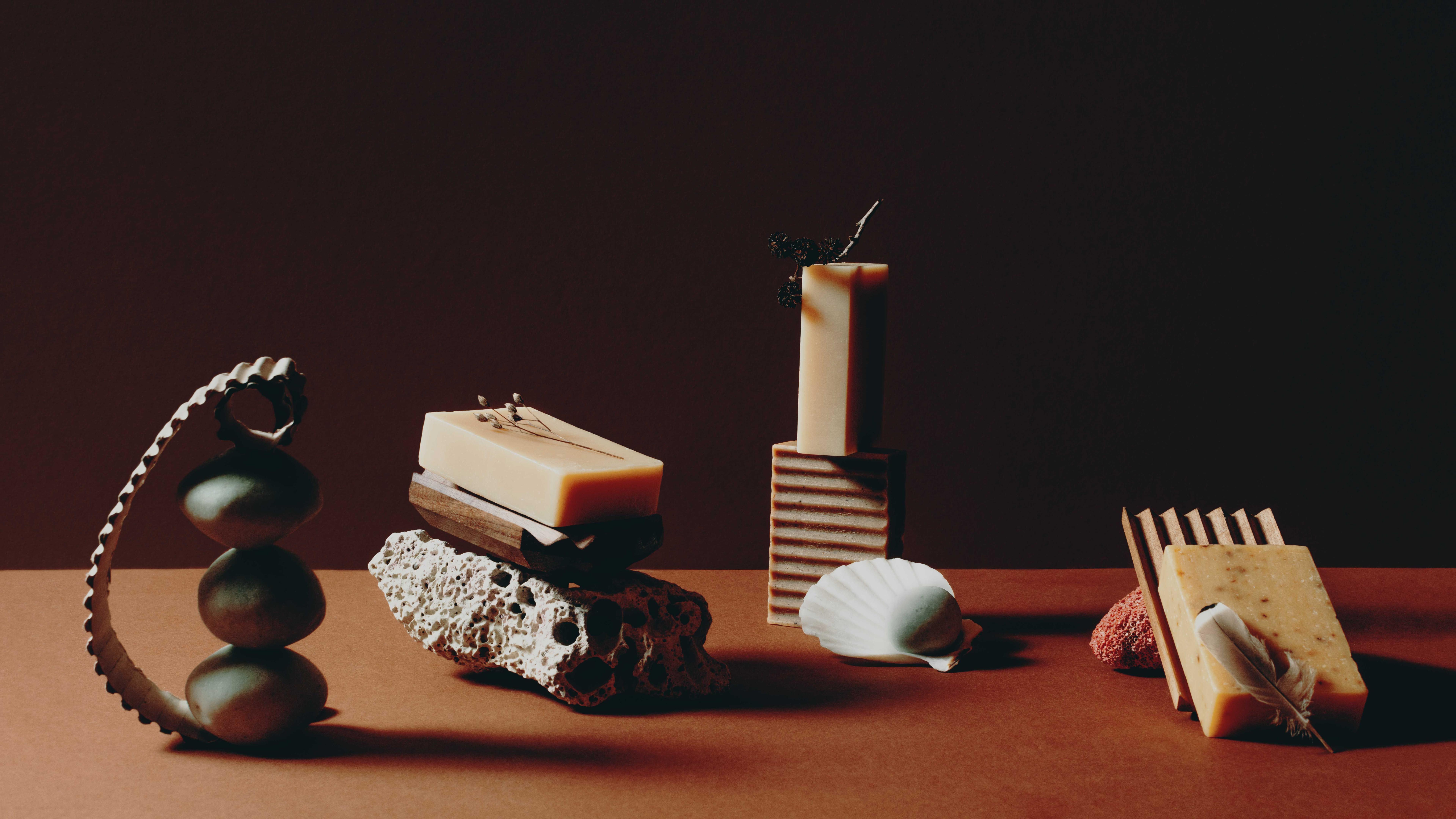 overview photo of several soaps and stones against blue background.