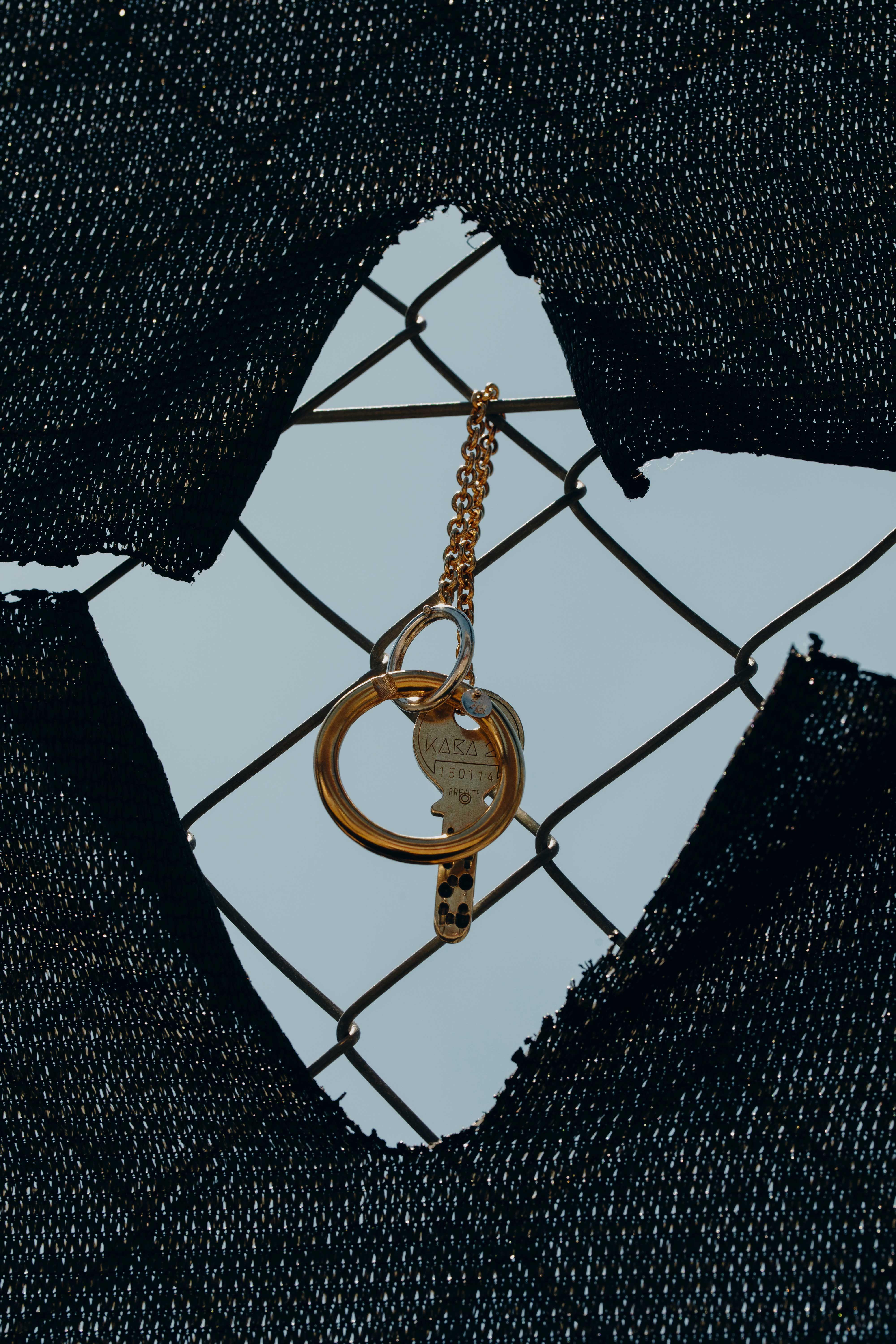 a bunch of keys hangs on a grate of a construction site barrier.