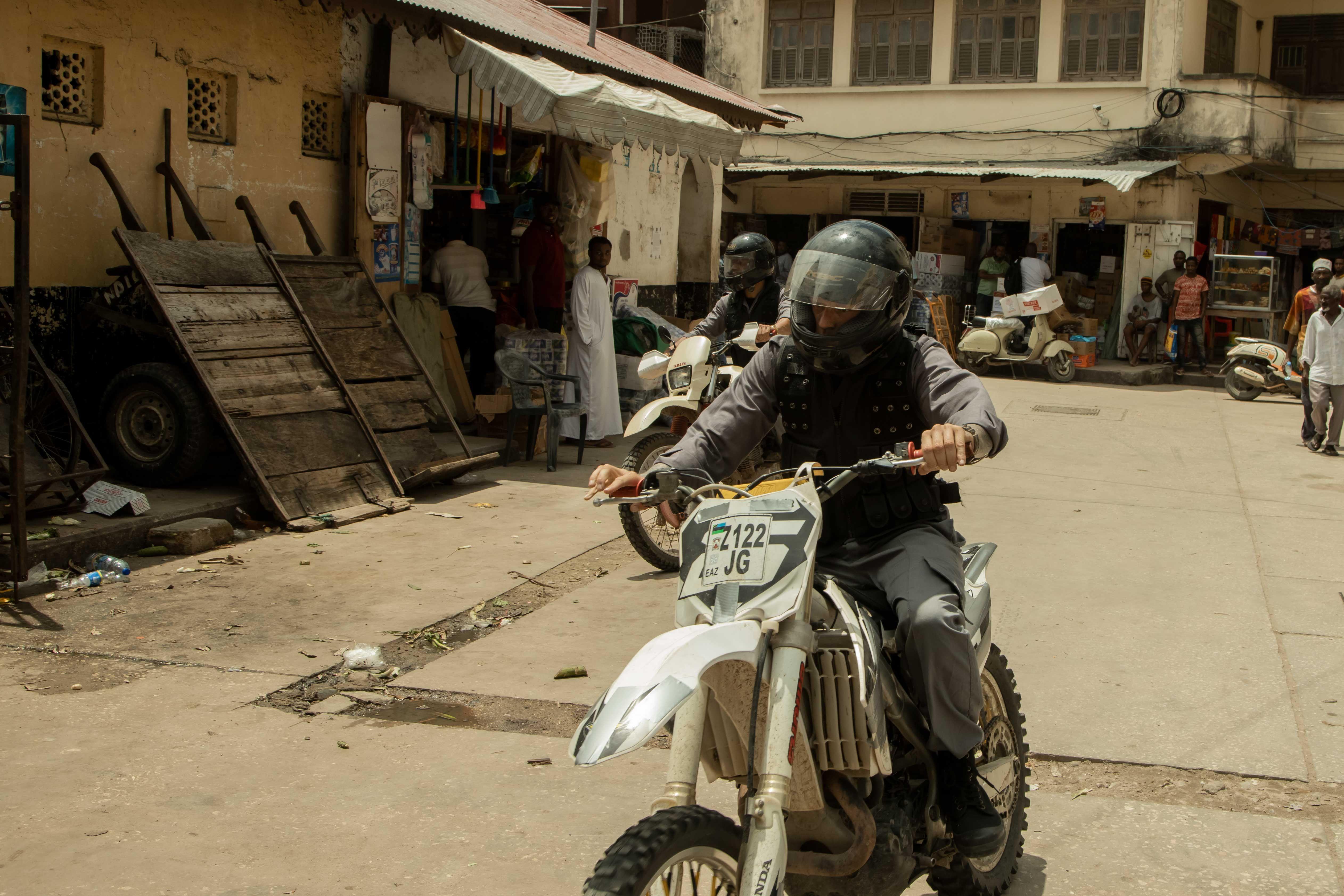 two men ride their motorcross through the streets of capstadt.